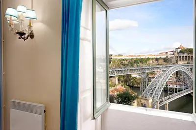 a room with a window with a view of a bridge at Manor House Porto in Porto
