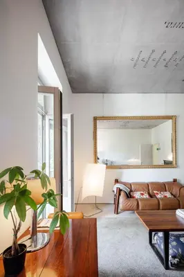 a living room with a couch and a mirror at Casa do Conto - Arts & Residence in Porto