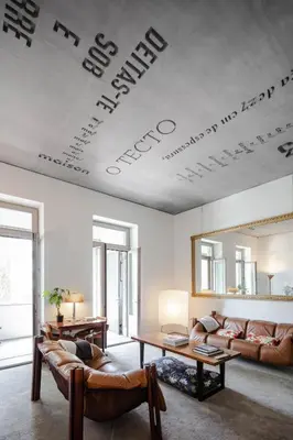 a living room with a couch and a mirror on the ceiling at Casa do Conto - Arts & Residence in Porto