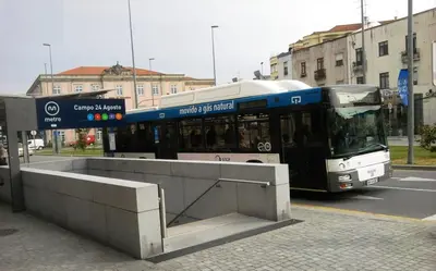 a bus is stopped at a bus stop at Visconde Garden in Porto