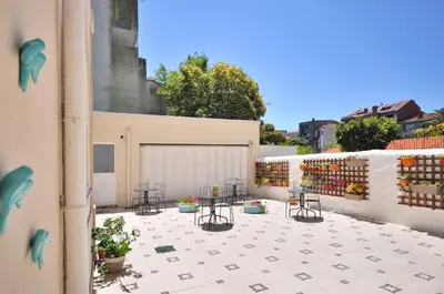 a patio with chairs and tables on a building at Porto Charming Hotel in Porto