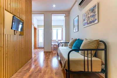 a bedroom with a bed and a tv on a wall at Fontainhas River Residence in Porto