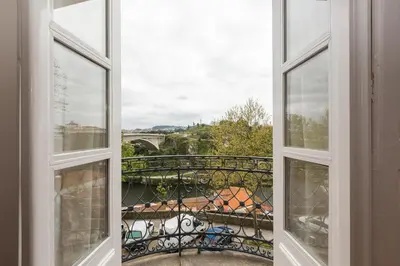 an open window with a view of a bridge at Fontainhas River Residence in Porto