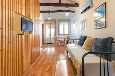 a living room with a couch and a dining room at Fontainhas River Residence in Porto