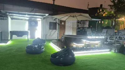 a backyard with a grill and a lawn with green grass at Ruby Charm Houses in Porto