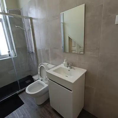 a bathroom with a sink and a toilet and a mirror at Guesthouse Monsanto in Porto