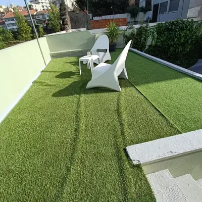 two white chairs sitting on top of a patch of grass at Guesthouse Monsanto in Porto