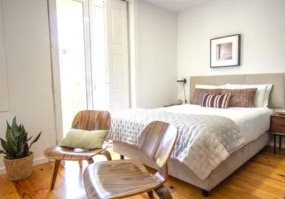 a bedroom with a large bed and two chairs at Formosa 79 Apartments by Guestify in Porto