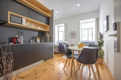 a kitchen and dining room with a table and chairs at Formosa 79 Apartments by Guestify in Porto