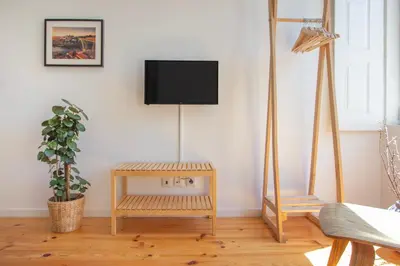 a living room with a flat screen tv on a wall at Formosa 79 Apartments by Guestify in Porto