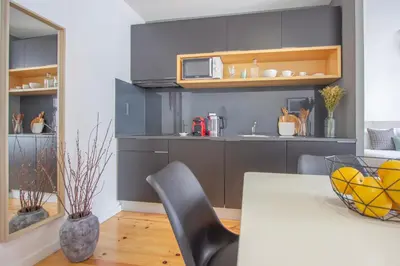 a kitchen with a table and a microwave at Formosa 79 Apartments by Guestify in Porto