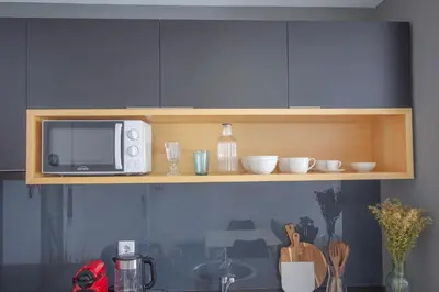 a microwave sitting on a shelf above a kitchen counter at Formosa 79 Apartments by Guestify in Porto