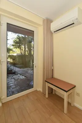 a room with a table and a door with a window at GR Suites in Porto