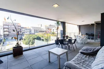 a living room with a couch and a large window at D João IV Apartment With Terrace by LovelyStay in Porto