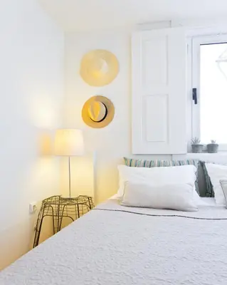 a bedroom with a white bed and a window at Own Places Cedofeita Apartments in Porto