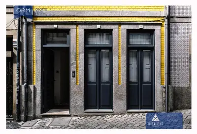 a building with three doors on the side of it at ORM - Mártires & Pinheiro Apartments in Porto