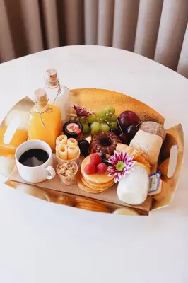 a tray of breakfast foods and coffee on a table at ORM - Mártires & Pinheiro Apartments in Porto