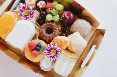 a box filled with different types of bread and fruit at ORM - Mártires & Pinheiro Apartments in Porto