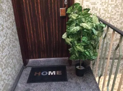 a home sign in front of a door with a plant at Downtown Sunny Apartment in Porto
