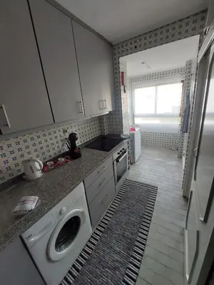 a kitchen with a washing machine in the counters at Comfort in the Downtown in Porto