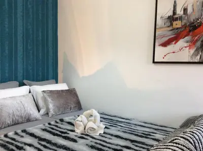 a room with a bed with a towel on it at Comfort in the Downtown in Porto