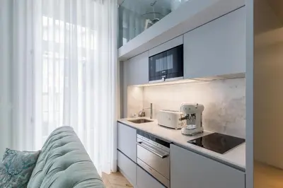 a kitchen with a counter and a sink and a couch at Villa Mouzinho by ON Apartments in Porto