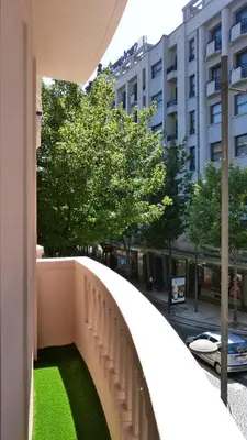 a balcony with green grass on the side of a building at Lux Bolhão - ALL INCLUDED in Porto
