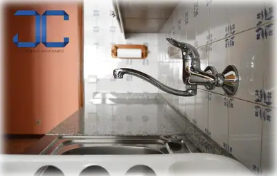 a sink in a kitchen with a faucet at Learn Porto Apartment by JC in Porto
