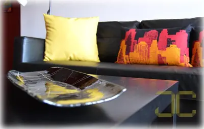 a glass coffee table in front of a couch at Learn Porto Apartment by JC in Porto