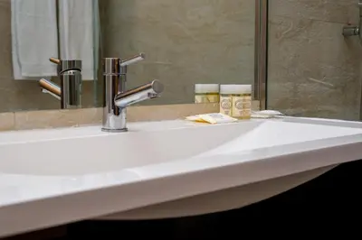 a bathroom sink with a faucet and a mirror at Pretty Porto Apartment by SOULSHARING.PORTO in Porto