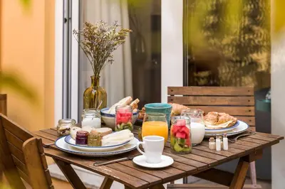 a wooden table with food and drinks on it at Bloom House by Sweet Porto in Porto