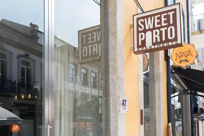 a sign on the side of a store with a sweet potato window at Bloom House by Sweet Porto in Porto