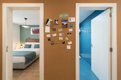 a bedroom with a bed and a wall with pictures at Bloom House by Sweet Porto in Porto