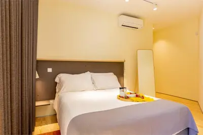 a hotel room with a bed with a tray on it at Feel Porto Codeçal Apartments in Porto