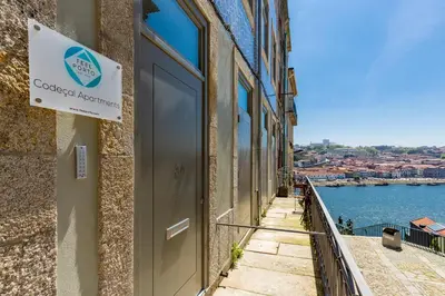 a sign on a building with a view of the water at Feel Porto Codeçal Apartments in Porto