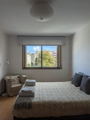 a bedroom with a large bed and a window at Pine Tree Apartment in Porto