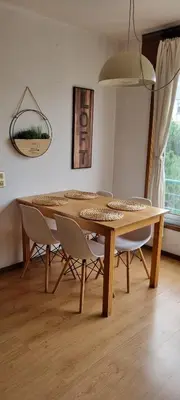 a dining room with a wooden table and chairs at Pine Tree Apartment in Porto