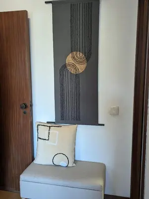 a pillow sitting on top of a ottoman in a room at Pine Tree Apartment in Porto