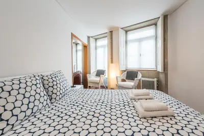 a bedroom with a large bed with pillows on it at GuestReady - Ao Coliseu in Porto