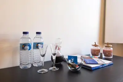 a table with two bottles of water and glasses at Home @ Porto Clérigos Apartment in Porto