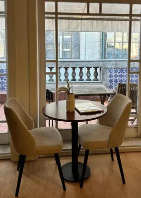 a table and two chairs in a room with a window at Be Oporto Apartments Clérigos in Porto