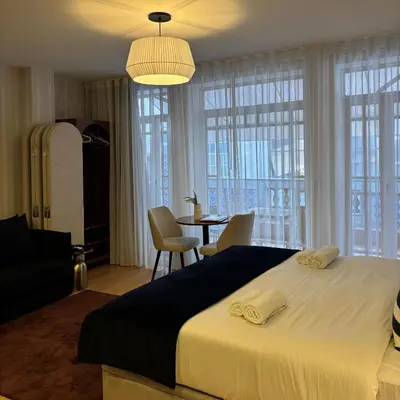 a bedroom with a large bed and a table with chairs at Be Oporto Apartments Clérigos in Porto
