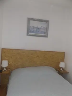 a bedroom with a bed with a picture on the wall at Casa do Largo in Porto