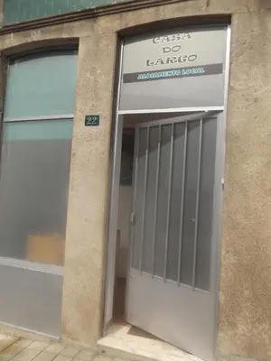 a garage door of a building with a sign on it at Casa do Largo in Porto