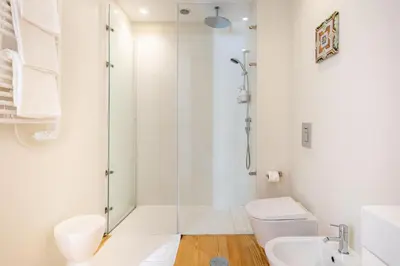 a bathroom with a shower and a toilet and a sink at Blue House Porto Apartments - Parking in Porto