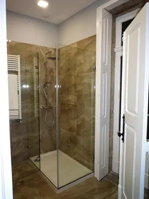 a shower with a glass door in a bathroom at Casa Familiar do Porto in Porto