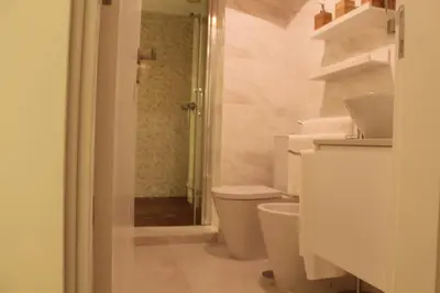 a white bathroom with a toilet and a shower at Apartment Garden Music in Porto
