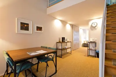 a room with a table and chairs and a clock at RVA - Gustave Eiffel Apartments in Porto