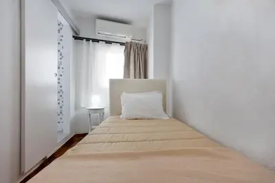 a bedroom with a bed with a pillow on it at Braganca Oporto in Porto