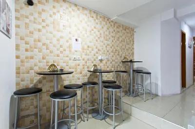 a row of bar stools against a brick wall at Braganca Oporto in Porto